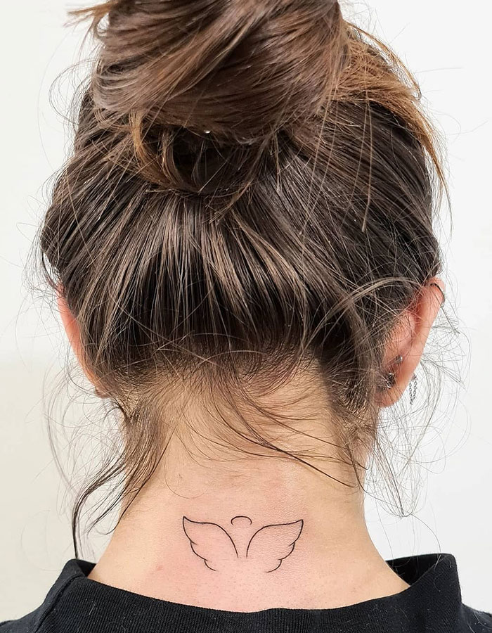 Minimalist tattoo design on a woman's neck, featuring angel wings for a subtle tattoo idea.