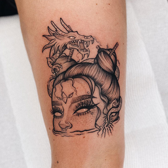 Tattoo design for women featuring a female face and a dragon on the arm.