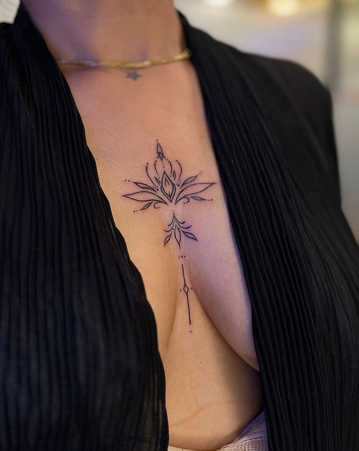 Elegant floral chest tattoo for women, showcasing delicate lines and subtle design.