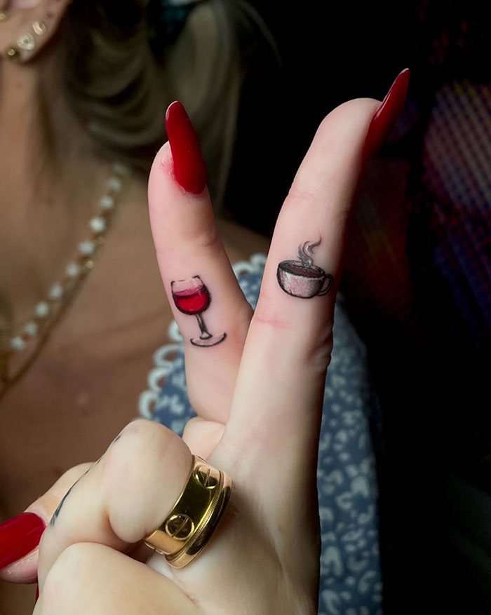 Finger tattoos on women with cup and wine glass designs, showcasing subtle and daring tattoo ideas.