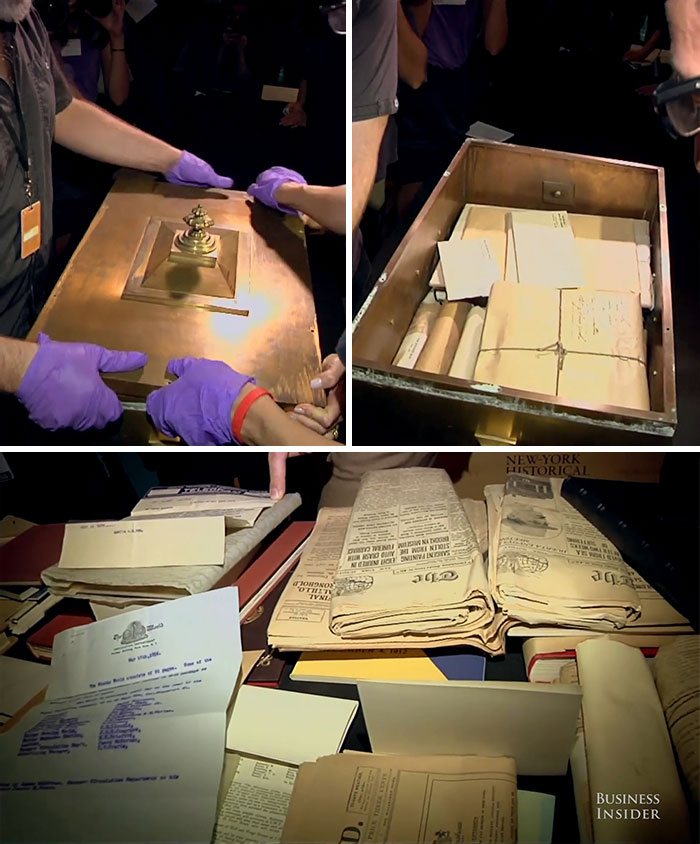 Unveiling historical time capsules with documents and artifacts, handled by people wearing purple gloves.