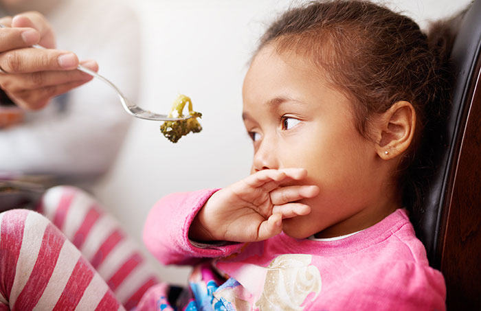 Child rejecting food with hand, looking away with displeasure. Child rejecting food with hand, looking away with displeasure.