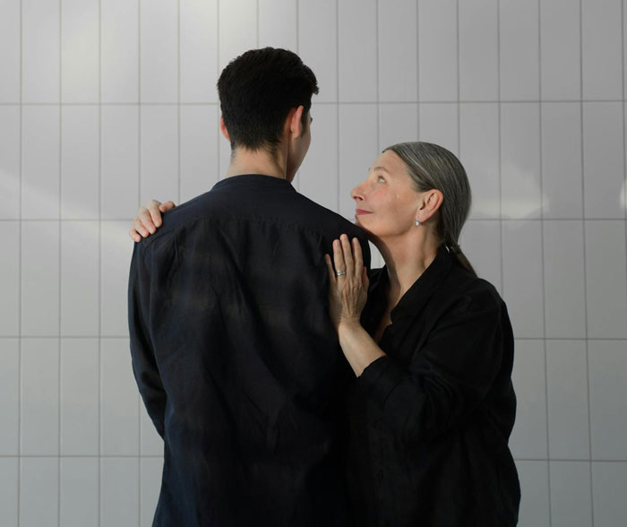 Woman embracing a family member, expressing contemplation, possibly related to a last-minute cruise cancellation decision. Woman embracing a family member, expressing contemplation, possibly related to a last-minute cruise cancellation decision.