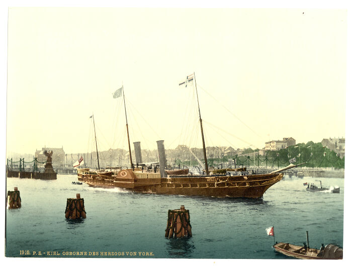 Historic color photo of a ship in a harbor, providing a glimpse of the world 100 years ago.