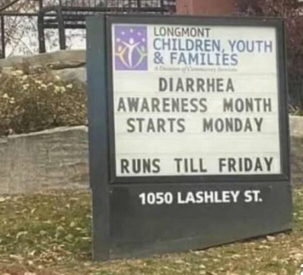 Weird and absurd sign outside Longmont Children, Youth & Families announcing "Diarrhea Awareness Month."