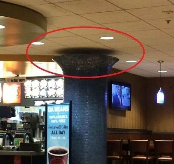 Construction mishap with ceiling misaligned on round column, highlighting a humorous architectural error.