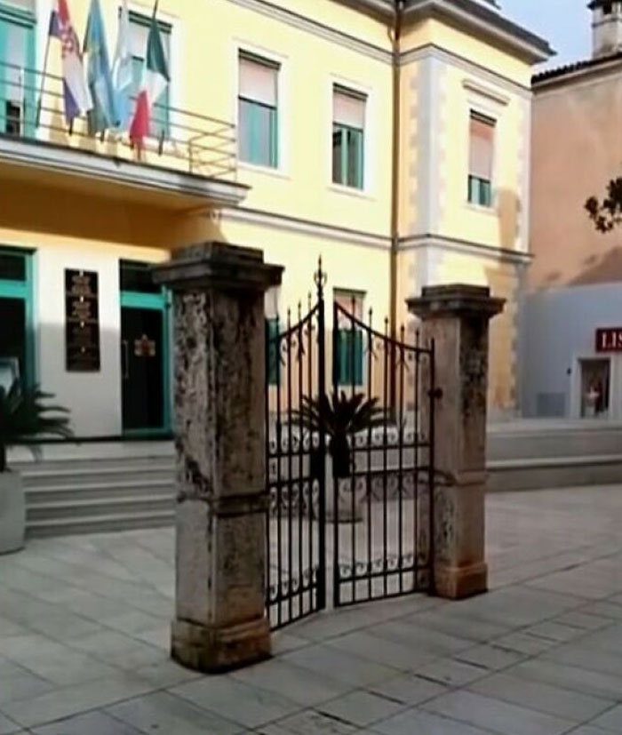 Misaligned gate in front of a building, showcasing a construction mistake.