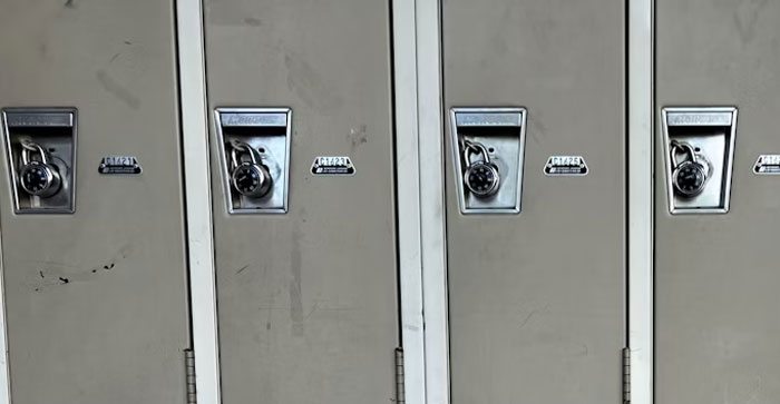Four secure lockers with combination locks, emphasizing security measures.