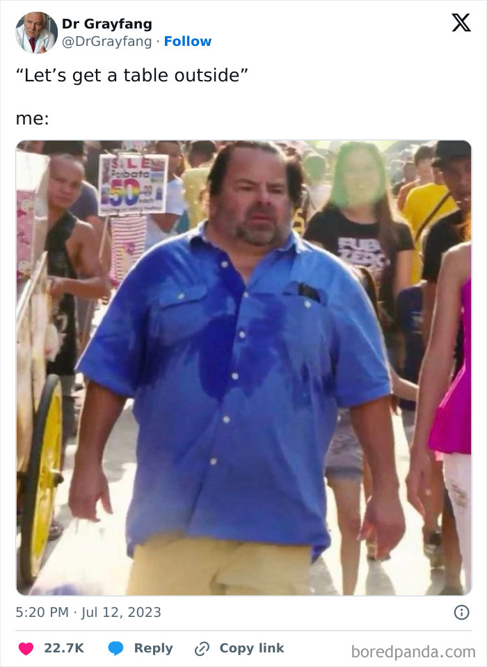 Man in a blue shirt sweating profusely, representing a funny meme like a dumpster fire moment.