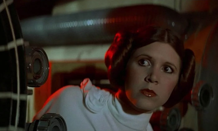 A strong female protagonist peering attentively, wearing a white outfit, in a science fiction setting.