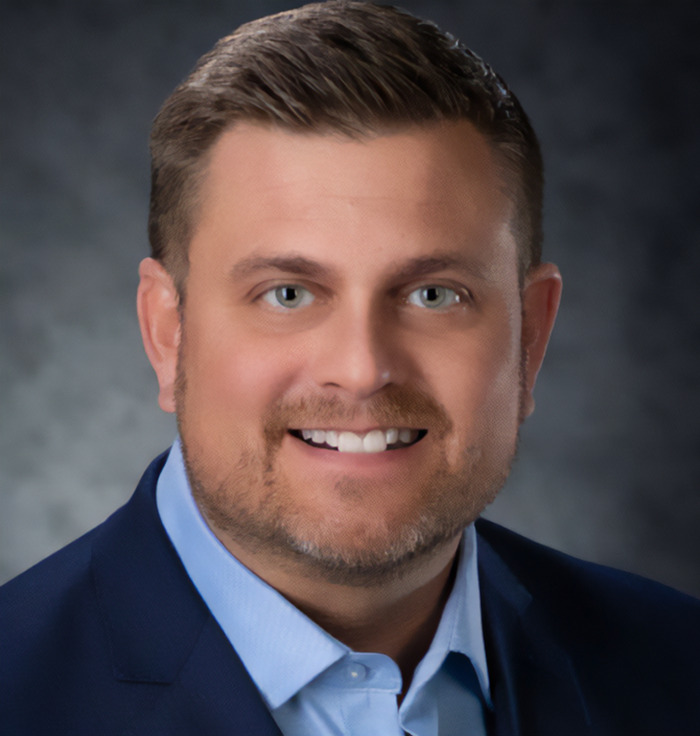 UnitedHealthcare CEO Brian Thompson in a suit, connected to McDonald&rsquo;s reviews incident.