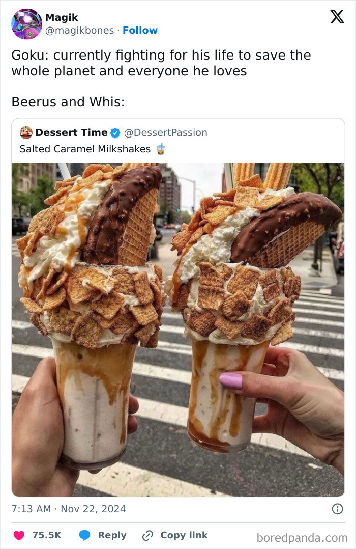 Two massive salted caramel milkshakes covered in cereal, topped with ice cream cones, held by two people on a city street.