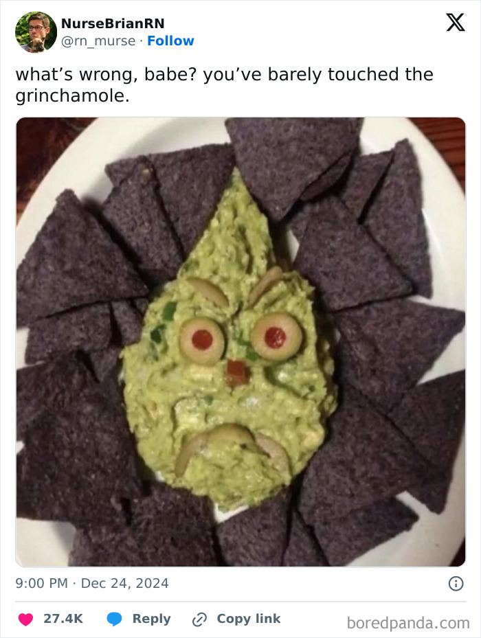 Guacamole styled like the Grinch, surrounded by blue tortilla chips.