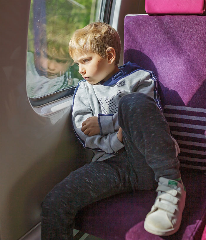 Child on a train looking out the window, reflecting on Santa Claus not being real. Child on a train looking out the window, reflecting on Santa Claus not being real.