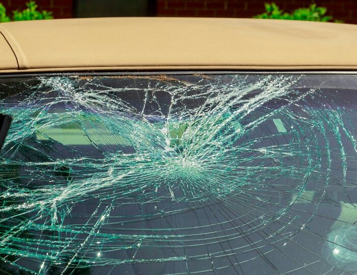 C*****d windshield on a car, symbolizing really messed up moments.