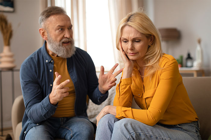 A woman in a yellow shirt listens to a bearded man, appearing upset, highlighting stepfamily Christmas drama. A woman in a yellow shirt listens to a bearded man, appearing upset, highlighting stepfamily Christmas drama.