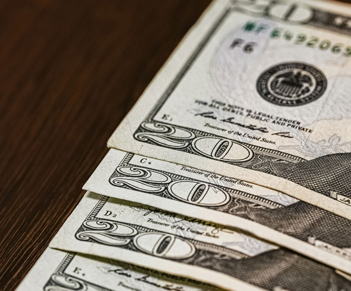 Dollar bills laid on a table symbolizing a surprise gift that went wrong.