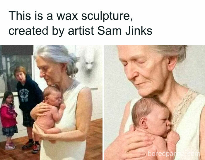 Wax sculpture by artist Sam Jinks, depicting an elderly woman holding a baby, on display with viewers observing.