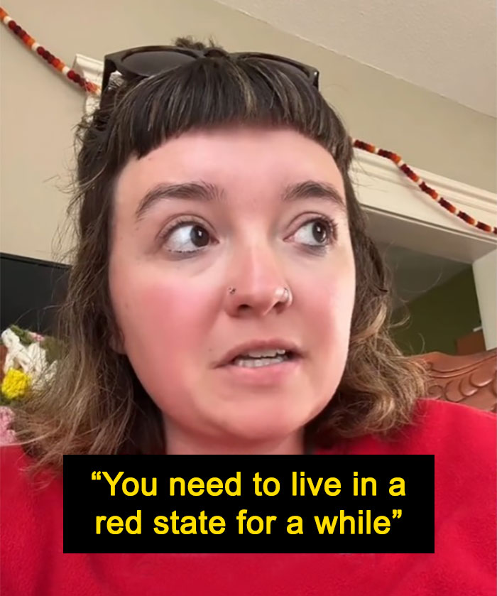 Woman shares thoughts on moving to a blue state, wearing a red shirt indoors, with a quote in bold text below.