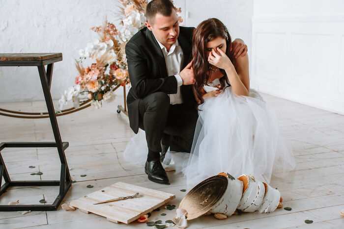 Bride and groom upset over a broken vase on their wedding day, highlighting worst things that happen at weddings.
