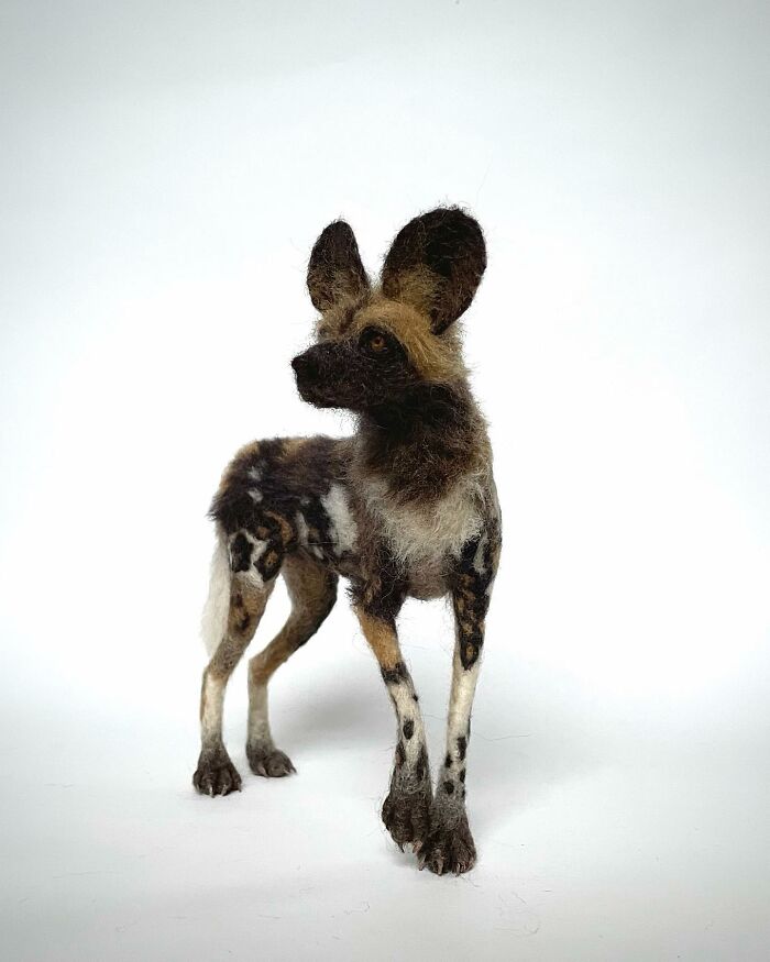 Needle-felted animal resembling a dog with large ears and intricate details.