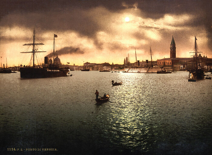 Historic color photo of Venice harbor, ships and gondolas in the water, showcasing a 100-year-old world scene.