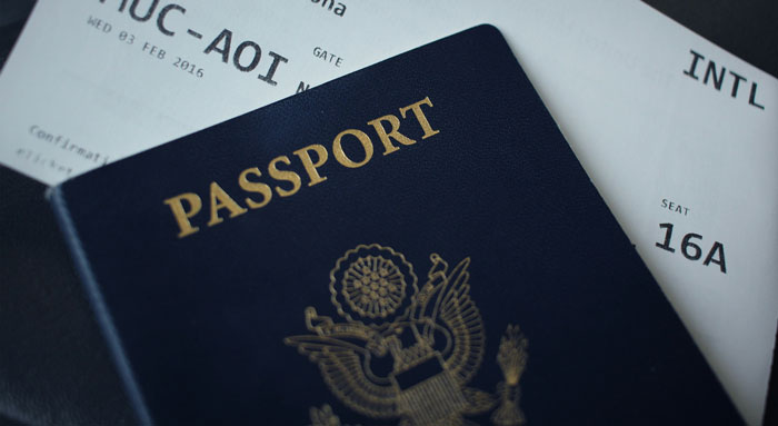 Passport and boarding pass on table, signifying man's thoughtful surprise plan.