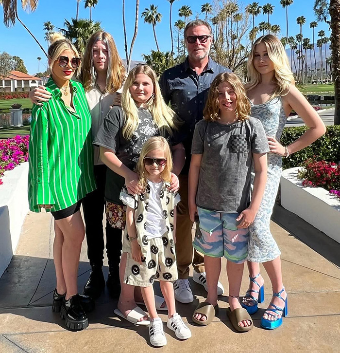 Tori Spelling with family outdoors.