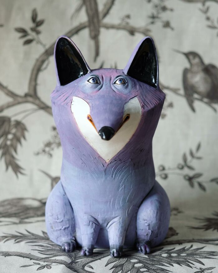 Playful ceramic sculpture of a purple fox with a whimsical design by Nastia Calaca.