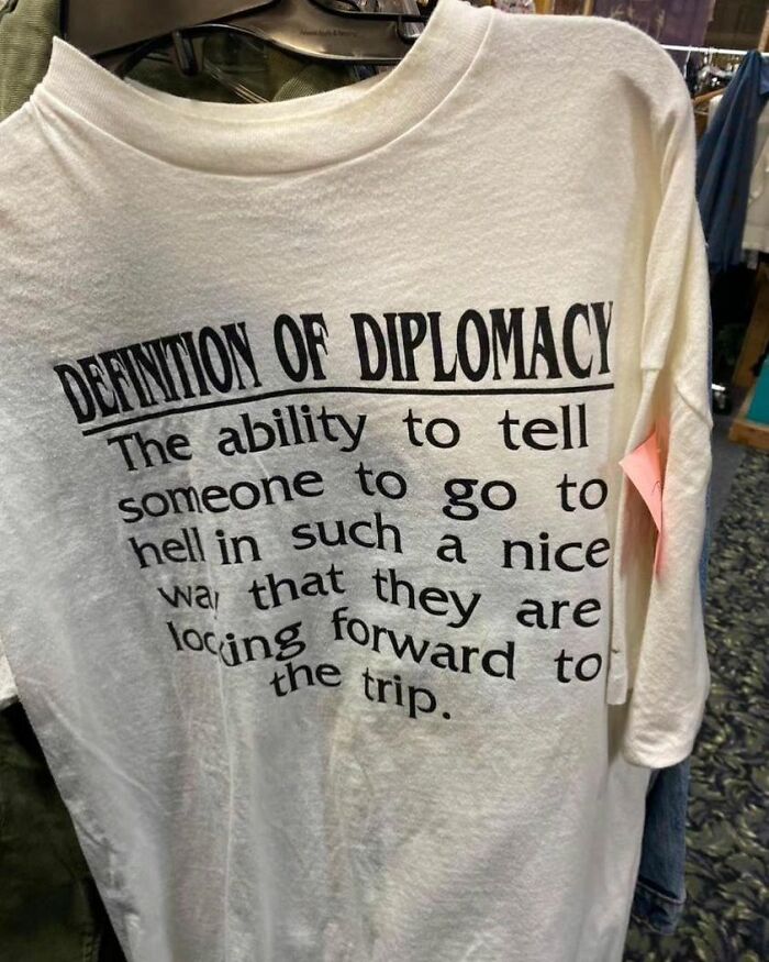 A weird shirt with a humorous definition of diplomacy printed on it.