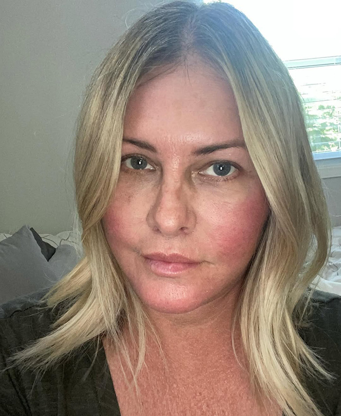 Nicole Eggert with straight hair in a casual setting.