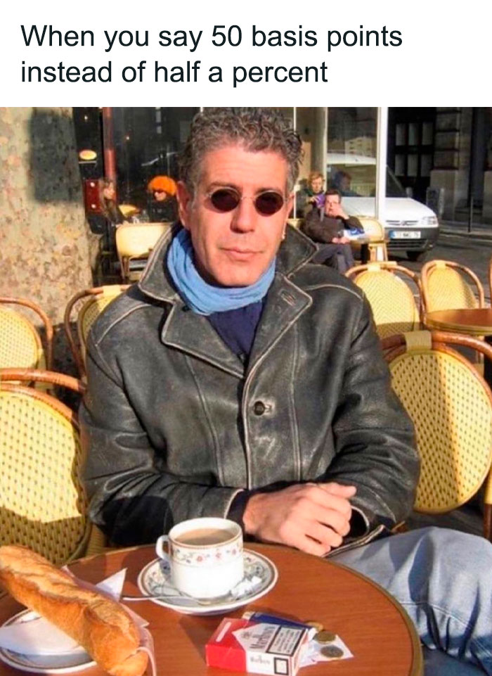 Person in sunglasses and leather jacket at an outdoor café with coffee and baguette, related to investment memes.