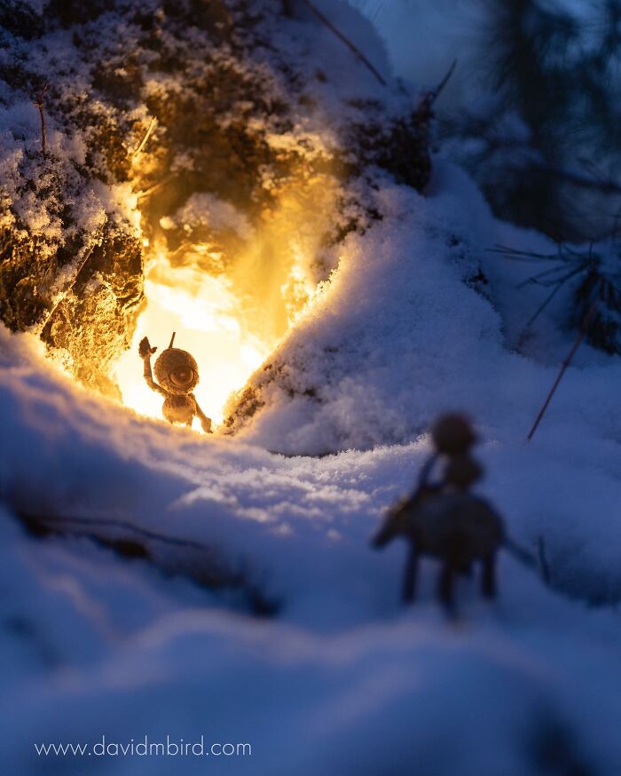 Becorn figure in a snowy landscape, illuminated by warm light from a tree hollow, showcasing creative design with natural materials.