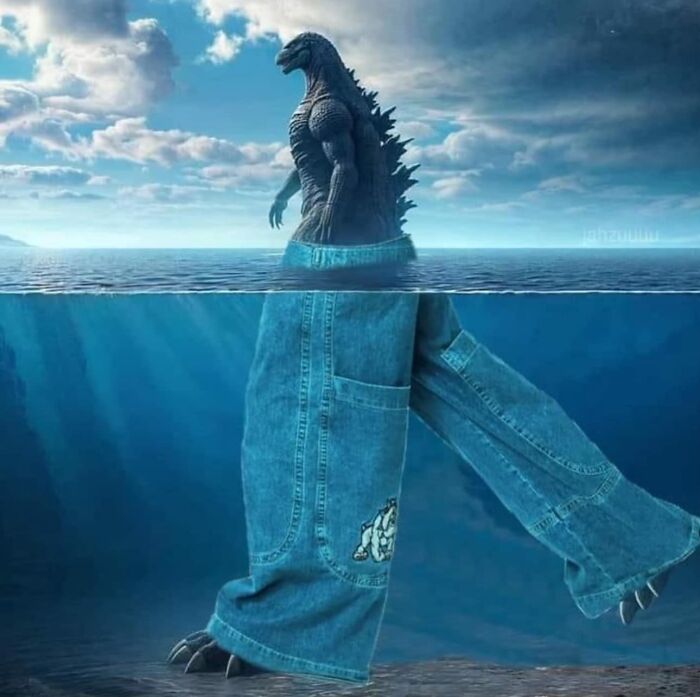 A giant creature in jeans emerges from the ocean, resembling a potential album cover image.
