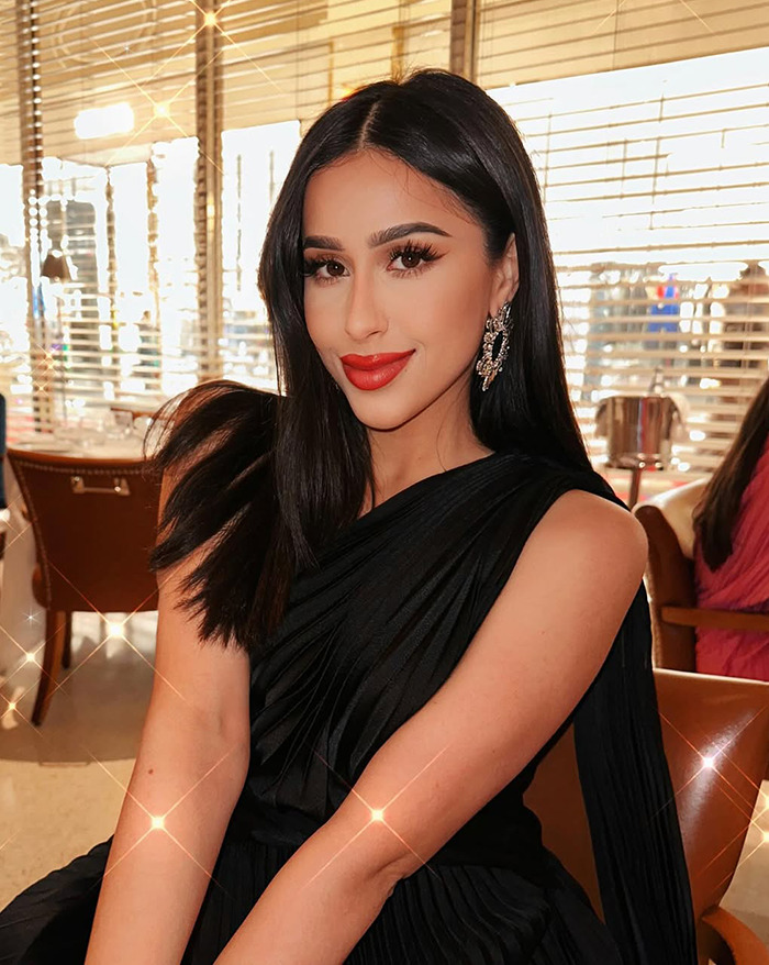 Dubai housewife Linda Andrade in elegant black dress at a restaurant, showcasing materialistic lifestyle.