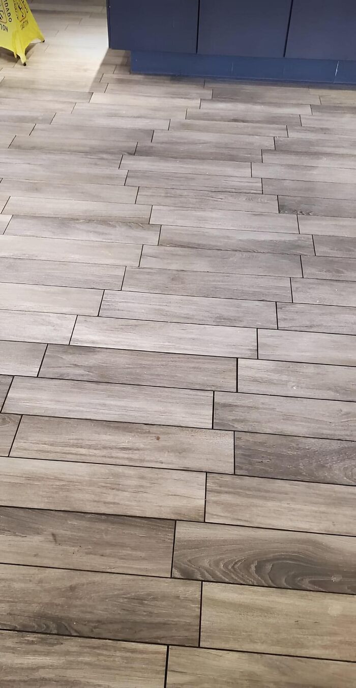 Uneven tile flooring showing a humorous construction fail.