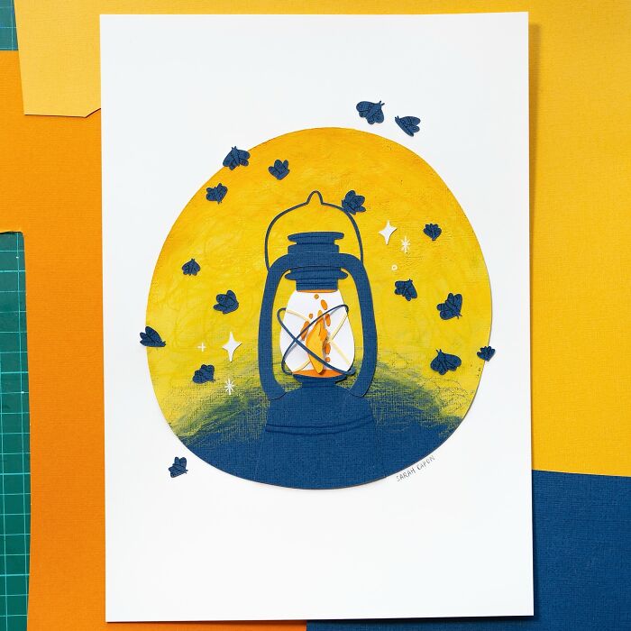 Layered paper illustration of a lantern surrounded by fireflies, showcasing a cute artistic design.