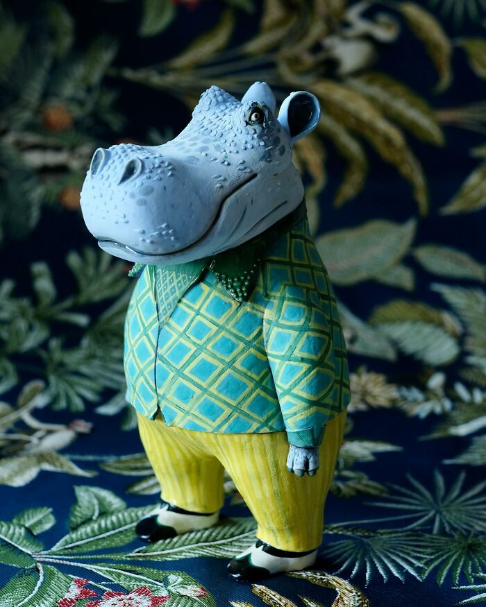 Playful ceramic sculpture of a hippo in colorful clothing, created by Nastia Calaca.