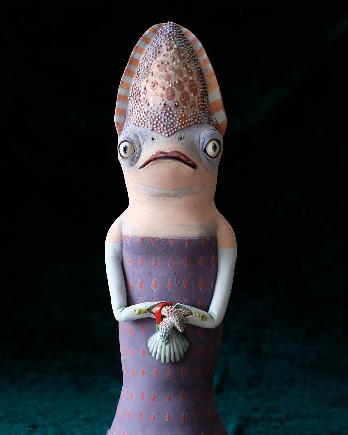 Playful ceramic sculpture of a whimsical creature with large eyes and patterned texture by Nastia Calaca.