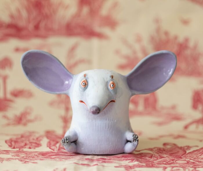 Playful ceramic sculpture by Nastia Calaca featuring a whimsical creature with large ears and a quirky expression.