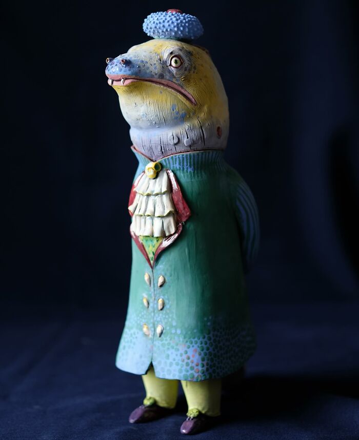 Playful ceramic sculpture by Nastia Calaca featuring a whimsical, colorfully dressed animal figure.