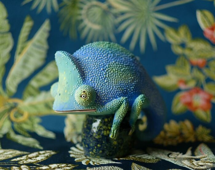 Colorful ceramic chameleon sculpture with textured pattern and intricate details by Nastia Calaca.