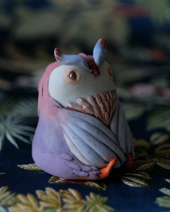 Playful ceramic owl sculpture by Nastia Calaca, featuring pastel colors and intricate detailing.