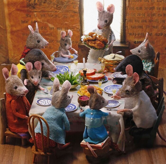 Miniature mice gathered around a dining table, sharing a meal in Maggie Rudy’s detailed Mouseland world.