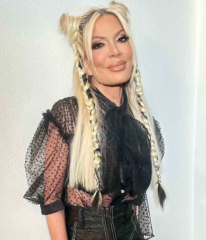 Tori Spelling with braided hair and sheer black top stands against a white background, related to "awful parenting" article.
