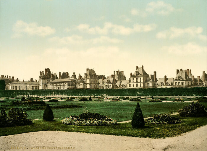 Old color photo of a historic palace and gardens, capturing world as it looked 100 years ago.