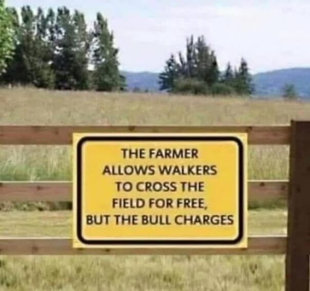 Weird and absurd sign in a field: "The farmer allows walkers to cross for free, but the bull charges."
