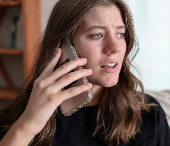 Woman on phone looking concerned about baby formula issues. Woman on phone looking concerned about baby formula issues.