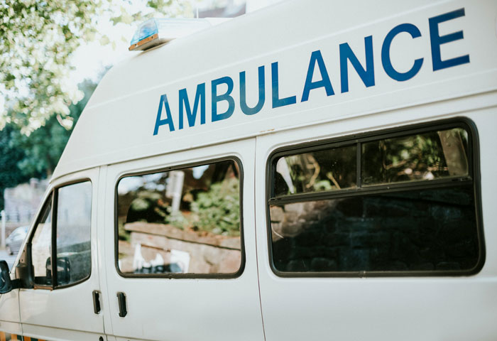 Ambulance parked by the roadside, possibly related to genuine speeding incident explanations to officers.