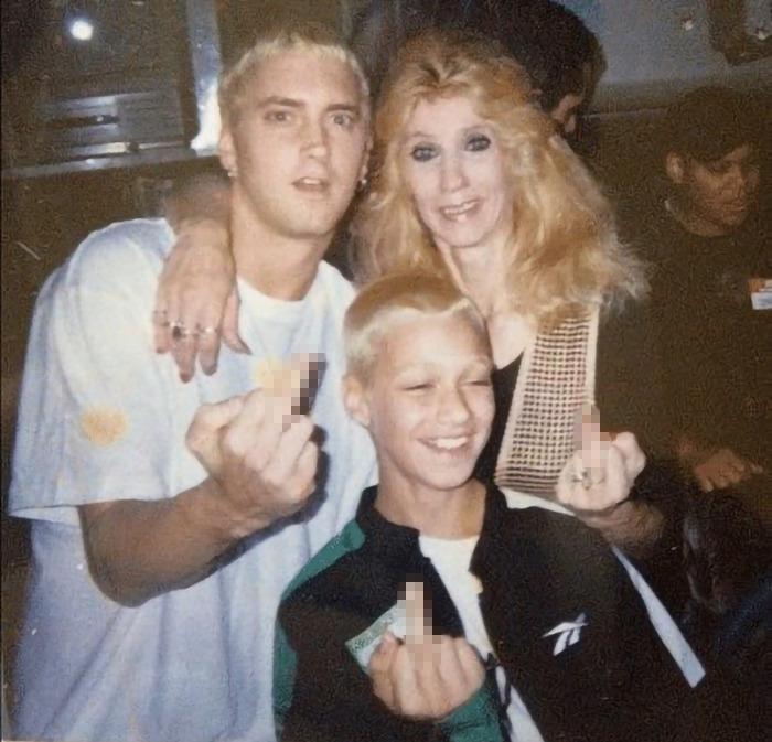 Three people in a candid moment, capturing a sense of emotion and family connection.